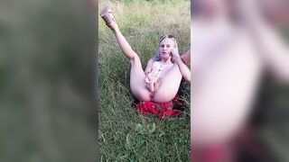 horny sexy woman in skirt in public shoves a dildo into her pussy